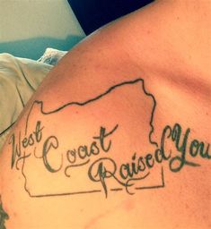 the back of a man's shoulder with his name and map tattooed on it