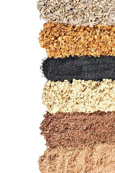 an assortment of seeds and grains arranged in rows on top of each other, including ground flakes