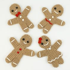 four crocheted gingerbread men with red noses