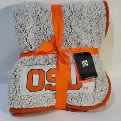 an orange and white blanket with the number 90 on it is wrapped in a ribbon