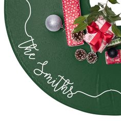 a green tray with presents and decorations on it