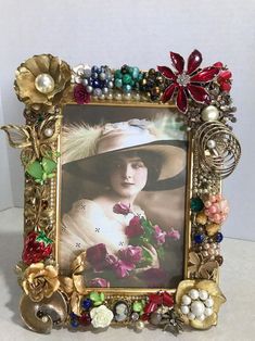 a photo frame with flowers and pearls on it