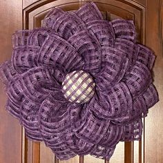 a purple wreath hanging on the front door