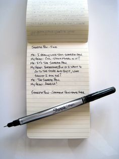 a notepad with writing on it next to a pen