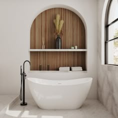 a large white bath tub sitting next to a window