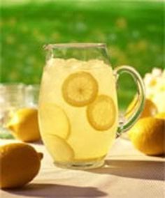 a pitcher filled with lemonade sitting on top of a table