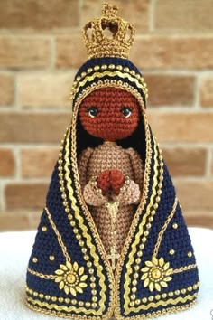 a crocheted doll with a crown on it's head