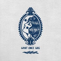 the logo for what once was, which features a woman's face in an ornate frame