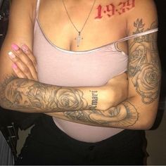 a woman with tattoos on her arms and chest