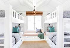 two bunk beds in a room with white walls and carpeted flooring, one bed is on the other side of the room