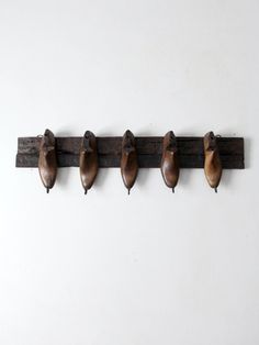 five wooden shoes are hanging on a wall