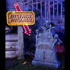 a sign that is next to a grave with skeletons on it and a jack - o'- lantern in the background