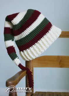 a crocheted hat sitting on top of a wooden chair