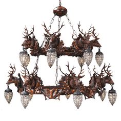 a chandelier with deer heads hanging from it's sides and lights on each side