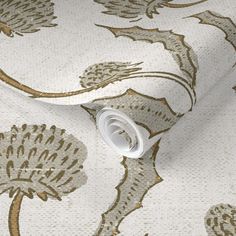 a white and gold wallpaper with flowers on it's side, in an elegant pattern