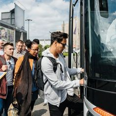 a group of people getting onto a bus