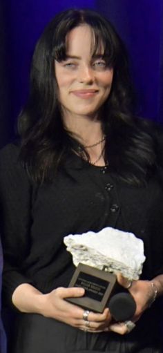 a woman holding an award in her hands