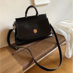 It's like being invited to the movie world of the good old days. A shoulder bag with a retro feel that makes you want to travel somewhere. Features a large flap. The golden clasp enhances the charm of the entire bag. The length of the shoulder strap is adjustable and can also be removed. 
 
 
 ＜Color＞ 
 
 Brown 
 Black 
 
 
 ＜Size＞ 
 
 
 FREE size 
 
 Height: 16.5cm 
 Width: 31cm 
 Depth: 12cm 
 
 
 
 
 
 ＜Material＞ 
 
 Leather Retro Office Satchel With Gold-tone Hardware, Retro Black Satchel For Daily Use, Retro Crossbody Bag With Gold-tone Hardware, Vintage Everyday Flap Shoulder Bag, Vintage Flap Bag With Detachable Strap For Everyday, Vintage Everyday Shoulder Flap Bag, Vintage Shoulder Bag With Adjustable Strap For Office, Everyday Vintage Shoulder Flap Bag, Everyday Vintage Style Shoulder Flap Bag