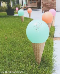 there are ice cream cones with sprinkles on them in the grass outside