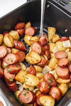 a pan filled with cooked sausage and potatoes