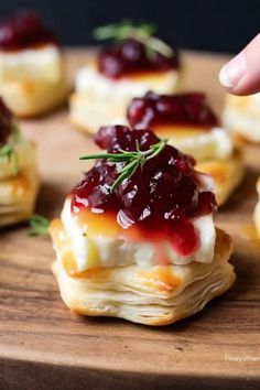 mini cranberry and cheese appetizers on a wooden platter