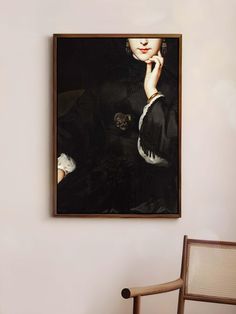 a painting hanging on the wall next to a chair