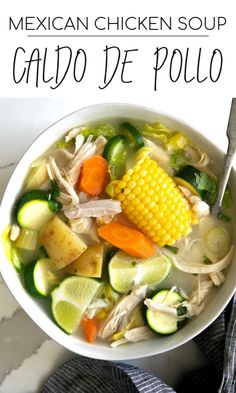 mexican chicken soup with vegetables and corn in a white bowl