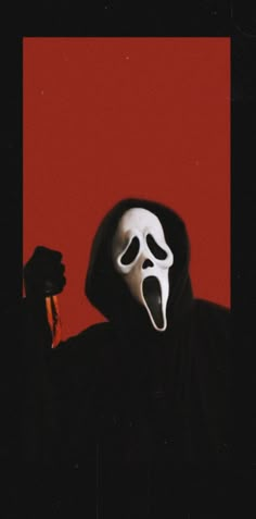 a person wearing a ghost mask and holding a knife