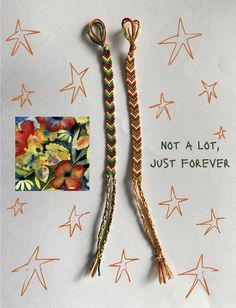 there are two pieces of rope with flowers on it and one has an orange flower in the middle