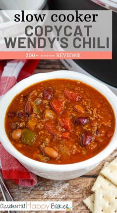 slow cooker copycat wendy's chili recipe in a bowl with crackers on the side