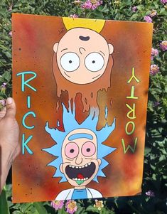 a person holding up a cartoon poster in front of some bushes and flowers with the words rick on it