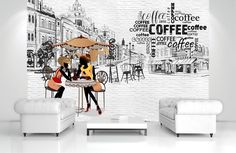 two women sitting at a table in front of a wall mural with coffee related words