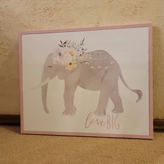 a greeting card with an elephant and flowers on it's head that says love blg