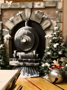 a train engine sitting in front of a fireplace with snow on the ground and trees around it