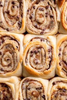 several cinnamon rolls are arranged in rows on top of each other