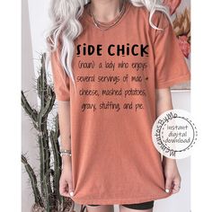 a woman with white hair wearing an orange shirt that says side chick on the front