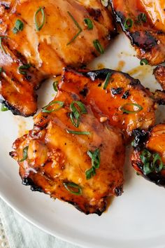 grilled buffalo chicken thighs on a white plate with text overlay that reads best ever grilled buffalo chicken thighs