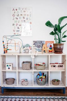 a wooden shelf with baskets and toys on it