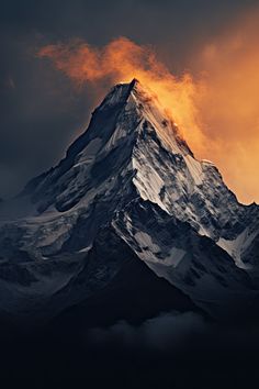 the top of a snow covered mountain with clouds in the sky and sun behind it