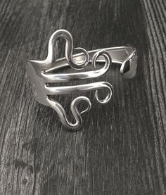 a silver ring sitting on top of a wooden table