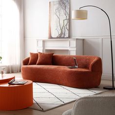 a living room with an orange couch and coffee table