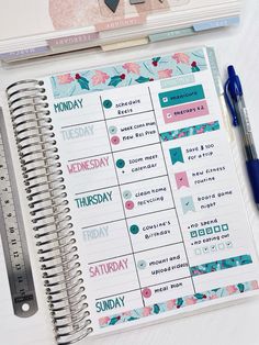 a planner and pen sitting on top of a table