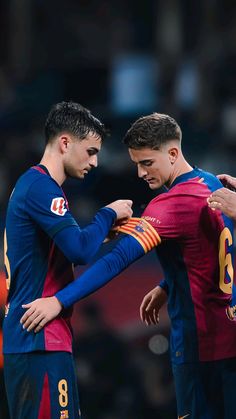 two soccer players standing next to each other