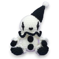 a crocheted stuffed animal wearing a black and white hat