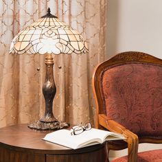 a lamp sitting on top of a table next to a chair