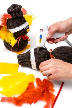 someone is using scissors to cut out the feathers for a turkey ornament craft