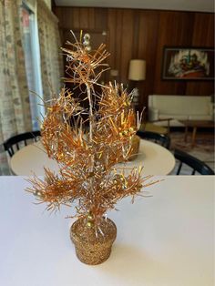 a small vase filled with lots of gold spiky plants on top of a white table