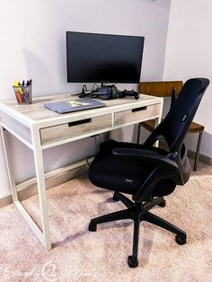 an office chair sits in front of a desk with a computer monitor and keyboard on it