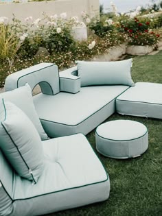 a couch and ottoman sitting in the grass