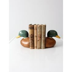 three books are stacked on top of each other in the shape of two duck heads